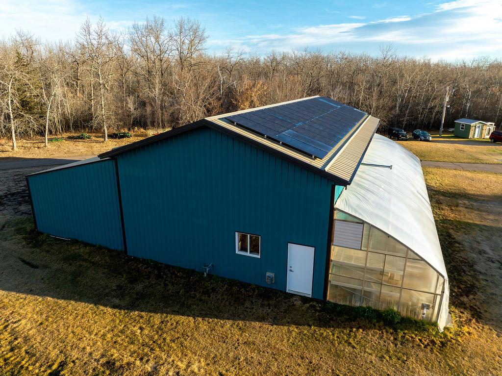 System sits on equipment shed and greenhouse